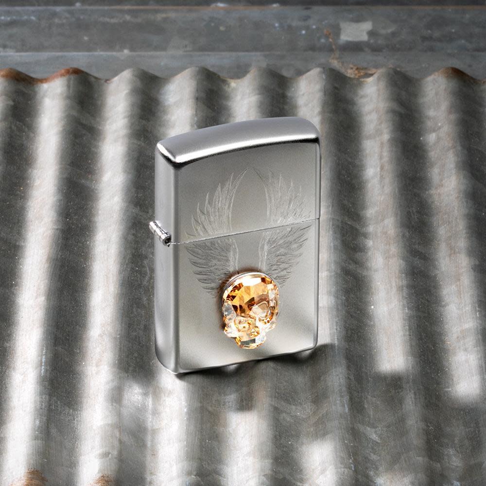 Front view of the Gold Skull Design Lighter with Skull Emblem on a metal background